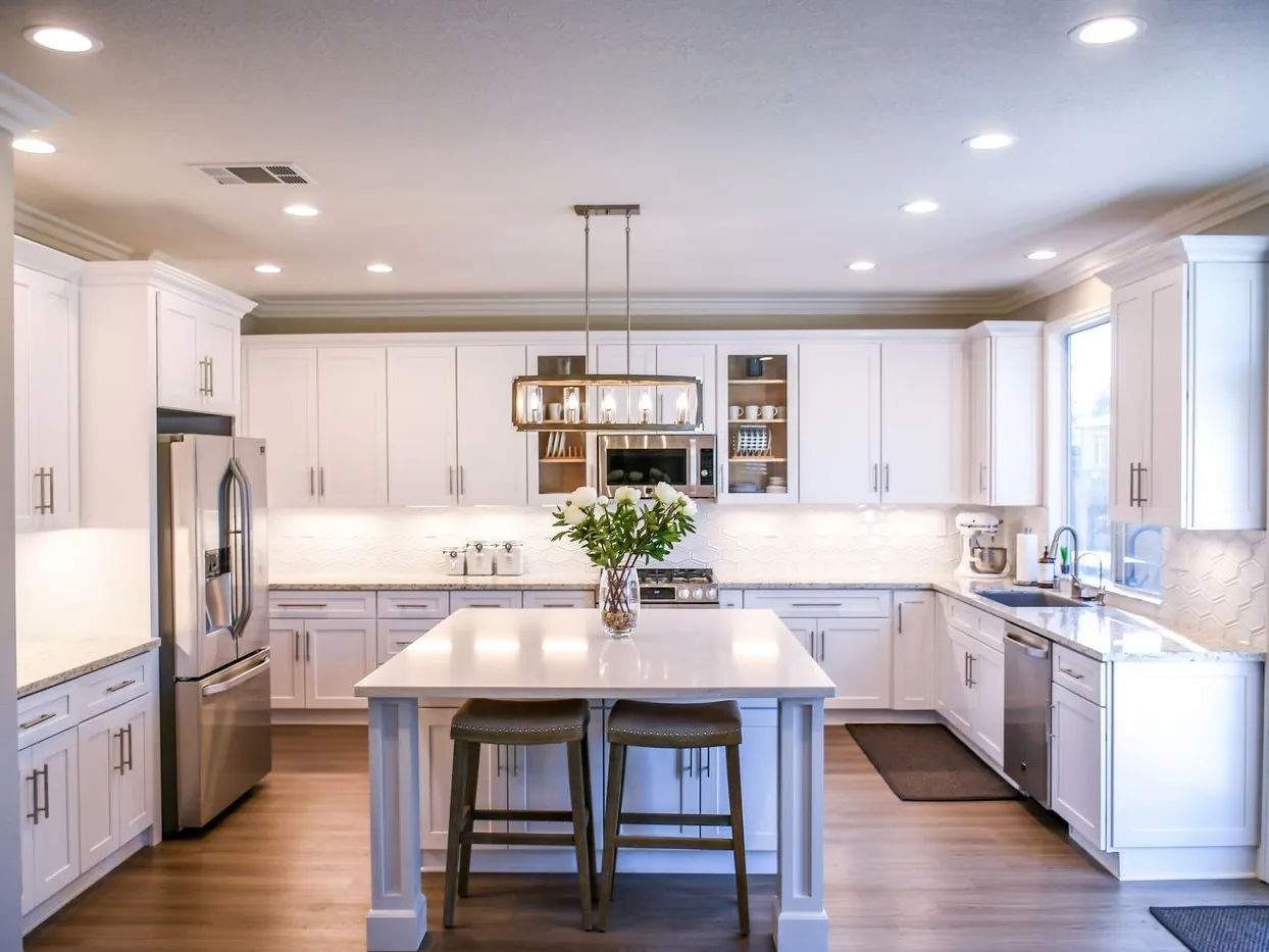 Kitchen island pendant lighting with recessed cans in a San Jose home