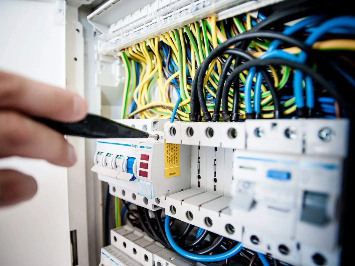 Electrician testing a breaker to diagnose a tripped circuit