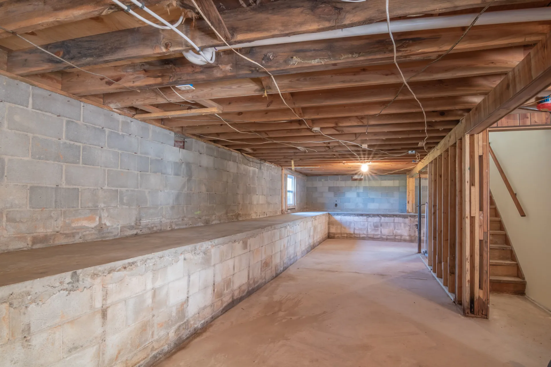 Unfinished room with exposed ceiling wiring during a whole-house rewire